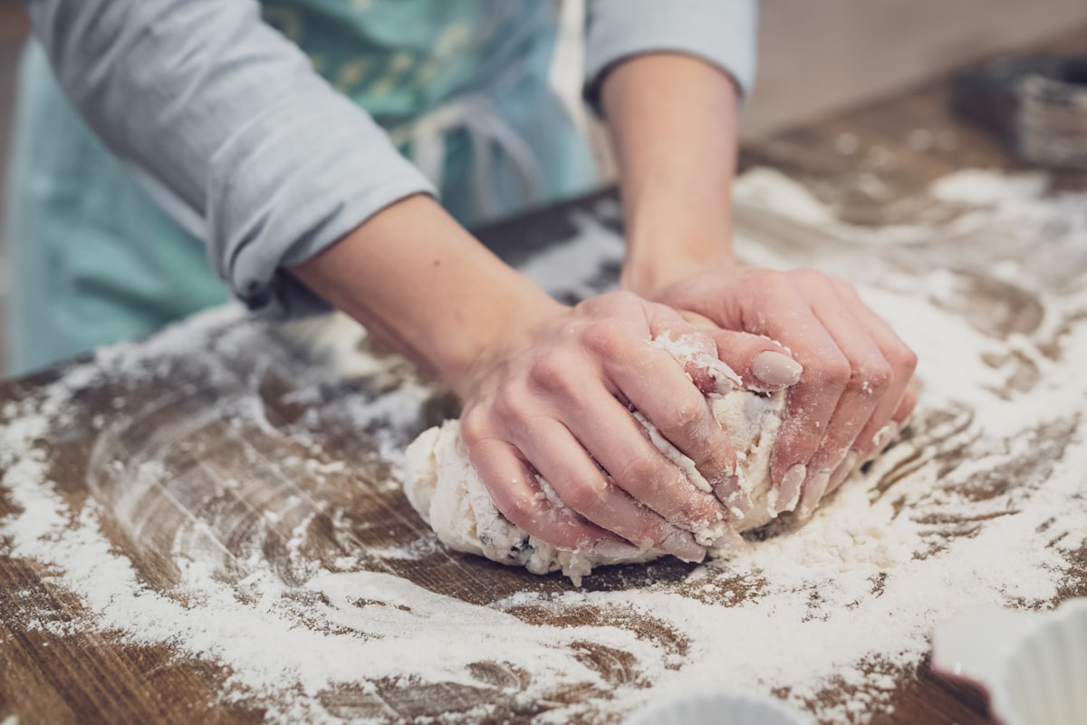 Hands kneading fresh cookie dough